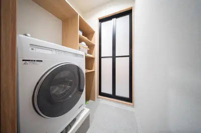 a washing machine in a room with a window at MARUMI HOTEL Uguisudani\u9daf\u8c37 in Tokyo
