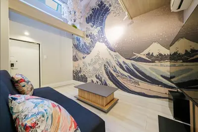a living room with a large mural of a wave at Hokusai Great Wave x Modern Japan in Tokyo