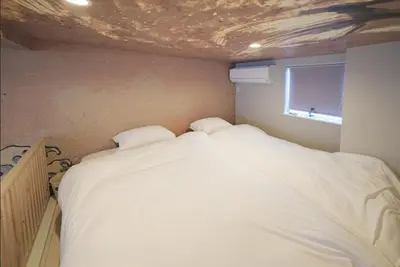 a bedroom with a large white bed and a window at Hokusai Great Wave x Modern Japan in Tokyo