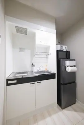 a kitchen with a sink and a black refrigerator at Hokusai Great Wave x Modern Japan in Tokyo