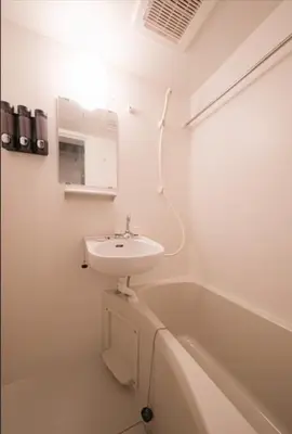 a white bathroom with a sink and a bath tub at Hokusai Great Wave x Modern Japan in Tokyo