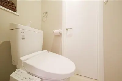 a bathroom with a white toilet and a door at Hokusai Great Wave x Modern Japan in Tokyo