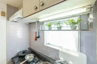 a kitchen with a window with potted plants on it at 603 8 min walk to Ikebukuro 6 min walk to Kanamecho Station25m Max 2 people Direct access to Tokyo, Shinjuku, Shibuya, Ueno in Tokyo