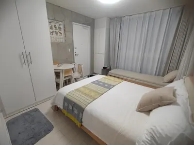a bedroom with a bed and a table in it at 302Room,7-minute walk from Uguisudani Station located on the 3nd floor of an apartment-style building Twin room No elevator in Tokyo
