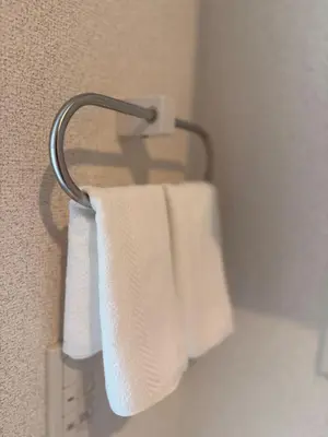 a towel rack with two white towels hanging on it at 302Room,7-minute walk from Uguisudani Station located on the 3nd floor of an apartment-style building Twin room No elevator in Tokyo
