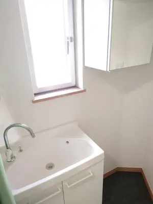 a bathroom with a white sink and a mirror at Uenton Hotel in Higashi-Mukojima 2F in Tokyo