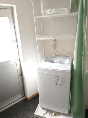 a washer and dryer sitting in a refrigerator at Uenton Hotel in Higashi-Mukojima 2F in Tokyo