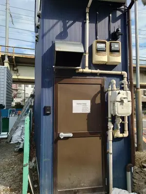 a blue building with a door and a television at Uenton Hotel in Higashi-Mukojima 2F in Tokyo