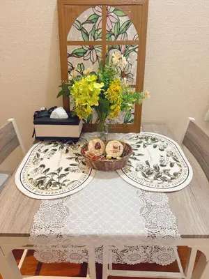 a table with two plates and a vase of flowers at F House Shinjuku in Tokyo