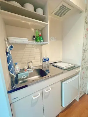 a small kitchen with a sink and a counter at F House Shinjuku in Tokyo