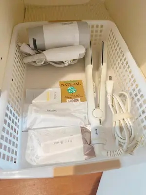 a white basket with utensils in a drawer at F House Shinjuku in Tokyo