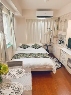 a bedroom with a bed and two rugs at F House Shinjuku in Tokyo