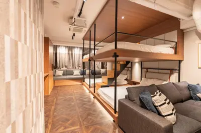 a living room with a couch and bunk beds at Villa Customa \u30f4\u30a3\u30e9\u30ab\u30b9\u30bf\u30de in Tokyo