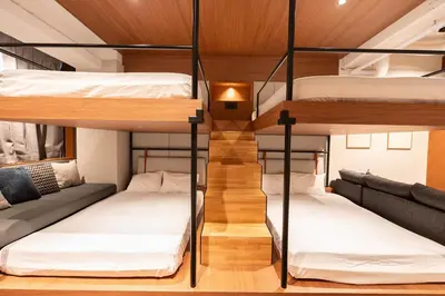 a room with four bunk beds and a staircase at Villa Customa \u30f4\u30a3\u30e9\u30ab\u30b9\u30bf\u30de in Tokyo
