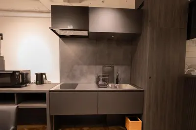 a kitchen with a sink and a counter top at Villa Customa \u30f4\u30a3\u30e9\u30ab\u30b9\u30bf\u30de in Tokyo