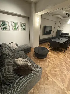 a living room with a couch and a table at Villa Customa \u30f4\u30a3\u30e9\u30ab\u30b9\u30bf\u30de in Tokyo