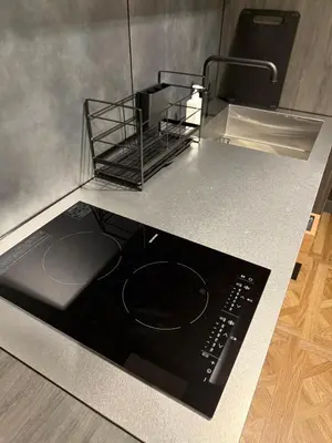 a kitchen with a stove top oven on a counter at Villa Customa \u30f4\u30a3\u30e9\u30ab\u30b9\u30bf\u30de in Tokyo