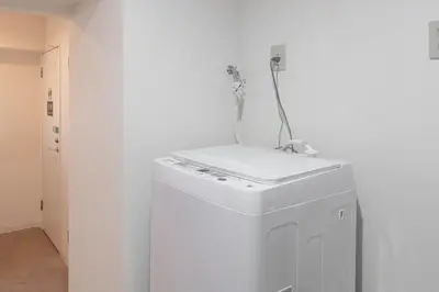 a washing machine with a cord on top of it at \u6771\u65b0\u5bbf1007 Good location within 15 minutes of Shinjuku Station in Tokyo