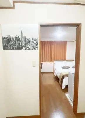 a bedroom with a bed and a black and white picture at 101 B&B in Tokyo Kita Ward Convenient Location Near 4 Stations 3 km to Ikebukuro Chinatown in Tokyo
