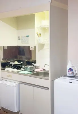 a white kitchen with a sink and a stove at 101 B&B in Tokyo Kita Ward Convenient Location Near 4 Stations 3 km to Ikebukuro Chinatown in Tokyo