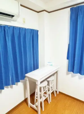a white table and two stools in a room with blue curtains at Tokyo Kita-ku B&B, 201, four stations with convenient transportation, 3 km from Chinatown Ikebukuro in Tokyo