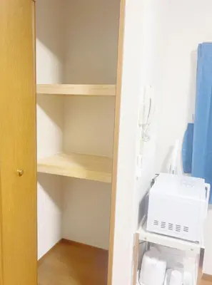a kitchen with a stove and a microwave on a shelf at Tokyo Kita-ku B&B, 201, four stations with convenient transportation, 3 km from Chinatown Ikebukuro in Tokyo
