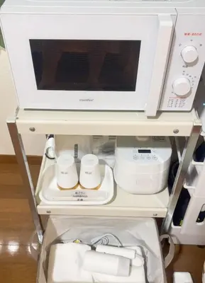 a microwave oven sitting on top of a refrigerator at Tokyo Kita-ku B&B, 202, convenient transportation to four stations, 3 km from Chinatown Ikebukuro in Tokyo
