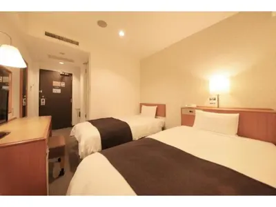 a hotel room with two beds and a television at Smile Hotel Tokyo Ayase Ekimae - Vacation STAY 14747v in Tokyo