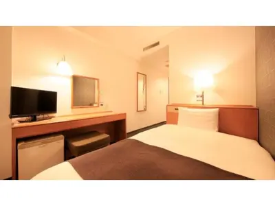 a hotel room with a bed and a desk with a television at Smile Hotel Tokyo Ayase Ekimae - Vacation STAY 14730v in Tokyo