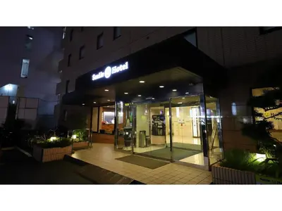 an entrance to a building with a sign on it at Smile Hotel Tokyo Ayase Ekimae - Vacation STAY 14741v in Tokyo