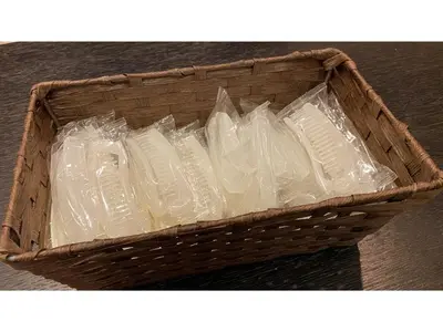 a basket full of plastic containers sitting on a table at Smile Hotel Tokyo Ayase Ekimae - Vacation STAY 14737v in Tokyo