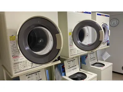 two washing machines and a washer and dryer on shelves at Smile Hotel Tokyo Ayase Ekimae - Vacation STAY 14737v in Tokyo
