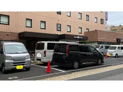 a group of cars parked in a parking lot at Smile Hotel Tokyo Ayase Ekimae - Vacation STAY 14737v in Tokyo