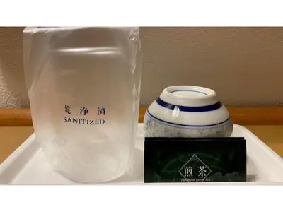 a white vase and a bag on a shelf at Smile Hotel Tokyo Ayase Ekimae - Vacation STAY 14755v in Tokyo