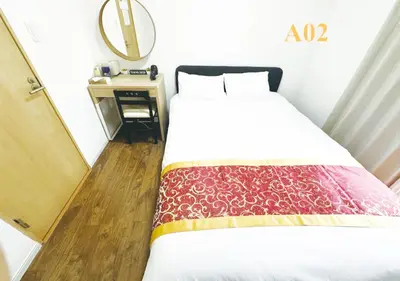a bedroom with a bed and a table with a mirror at Tabata Flower Village - Vacation STAY 45842v in Tokyo