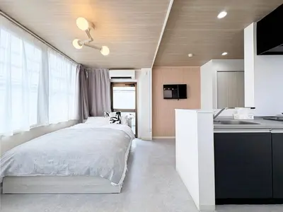 a small bedroom with a bed and a kitchen at Belshaart Kamikitazawa - Vacation STAY 20239 in Tokyo