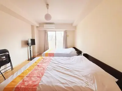 a bedroom with two beds and a window at Ars Building 302 - Vacation STAY 41407v in Tokyo