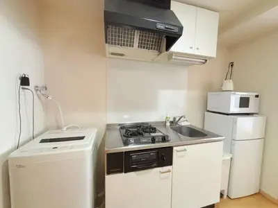 a small kitchen with a stove and a refrigerator at Ars Building 302 - Vacation STAY 41407v in Tokyo