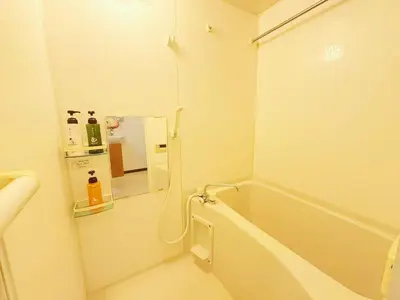a white bathroom with a tub and a mirror at Ars Building 302 - Vacation STAY 41407v in Tokyo