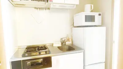 a small kitchen with a stove and a microwave at Ars Building 401 - Vacation STAY 45980v in Tokyo