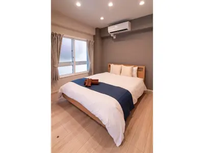 a bedroom with a large bed with white sheets and a window at VOERE KAMEIDO - Vacation STAY 48878v in Tokyo