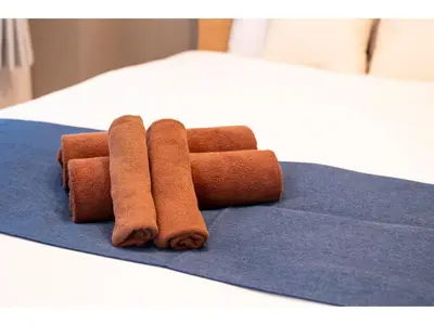 a pile of toilet rolls sitting on a blue towel at VOERE KAMEIDO - Vacation STAY 48878v in Tokyo