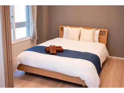 a brown teddy bear sitting on a bed at VOERE KAMEIDO - Vacation STAY 48878v in Tokyo