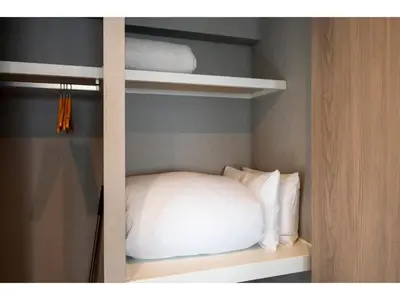 a bedroom with a white pillow on a shelf at VOERE KAMEIDO - Vacation STAY 48867v in Tokyo