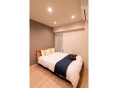 a bedroom with a bed with a dog laying on it at VOERE KAMEIDO - Vacation STAY 48034v in Tokyo