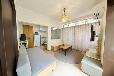 a living room with a couch and a table at Hajime Stay in Tokyo