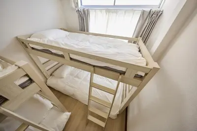 a bunk bed in a small room with a window at Hajime Stay in Tokyo
