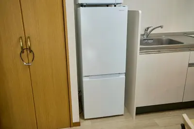 a white refrigerator in a kitchen next to a sink at Hajime Stay in Tokyo