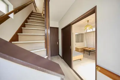 a staircase in a house with a hallway and a room at Hajime Stay in Tokyo