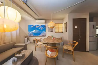 a living room with a table and a couch at Wooden warmth of a house 8 people Skytree 7 minutes 75 square meters Asakusa, Shibuya, Narita, Haneda direct in Tokyo